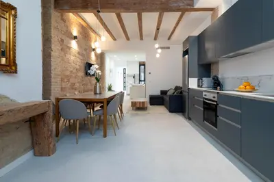 a kitchen and dining room with a table and chairs at My Loft 4 You Patraix Style in Valencia