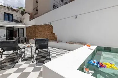 a patio with a pool and chairs and a table at My Loft 4 You Patraix Style in Valencia