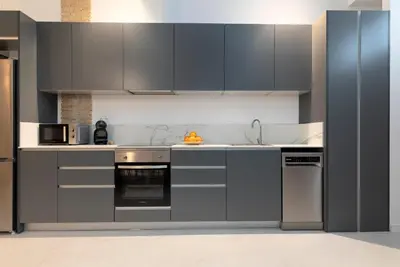a kitchen with stainless steel appliances and gray cabinets at My Loft 4 You Patraix Style in Valencia