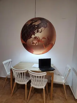 a table with a laptop and a globe on the wall at Living Valencia Apartments - Merced in Valencia