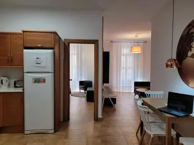 a kitchen and dining room with a refrigerator and a table at Living Valencia Apartments - Merced in Valencia