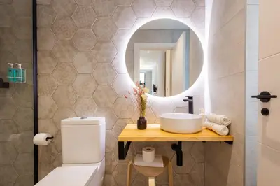 a bathroom with a sink and a mirror at FLORIT FLATS - Trafalgar Arts & Port Suites in Valencia