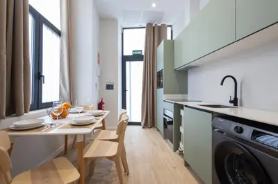 a kitchen and dining room with a table and chairs at FLORIT FLATS - Trafalgar Arts & Port Suites in Valencia