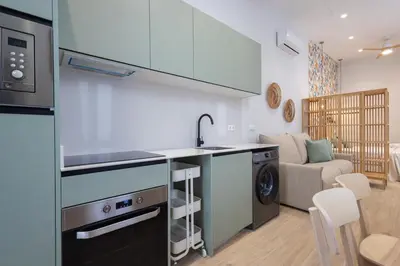 a kitchen with a sink and a washing machine at FLORIT FLATS - Trafalgar Arts & Port Suites in Valencia