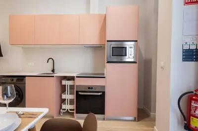 a small kitchen with a stove and a microwave at FLORIT FLATS - Trafalgar Arts & Port Suites in Valencia
