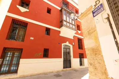 a red building with a door on a street at GuestReady - A perfect stay in Ciutat Vella in Valencia
