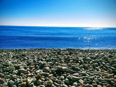 a large group of rocks on a beach near the ocean at Beach,s House in Playa del Puig in La Torre
