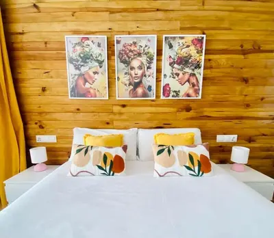 a bedroom with a bed with four pictures on the wall at Beach Flat for Family & Groups in Valencia