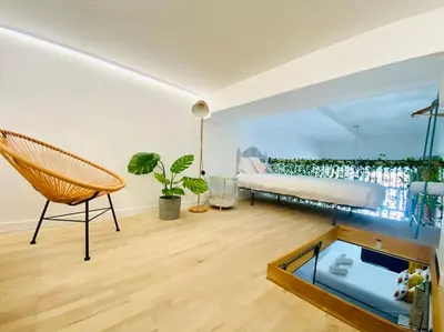 a living room with a couch a chair and a window at Beach Flat for Family & Groups in Valencia