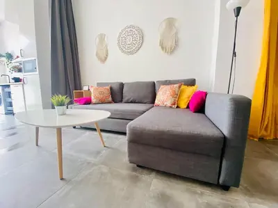 a living room with a couch and a table at Beach Flat for Family & Groups in Valencia