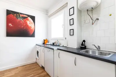 a kitchen with a sink and a washing machine at Mestalla Apartment Ideal for Mid-Term Stays in Valencia