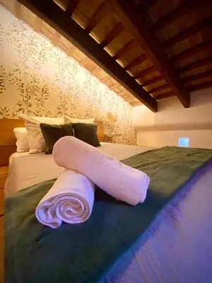 a rolled up towel on top of a bed at Aire in Valencia