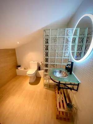 a bathroom with a sink and a toilet and a mirror at Aire in Valencia