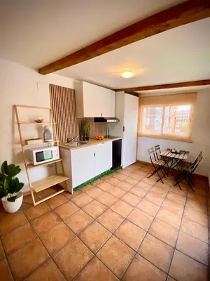 a kitchen with a table and chairs in a room at Aire in Valencia