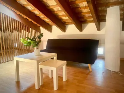 a living room with a table and a couch at Aire in Valencia