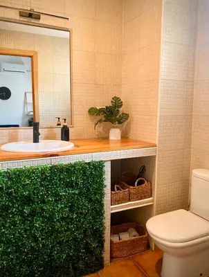 a bathroom with a sink and a toilet and a mirror at Tierra in Valencia