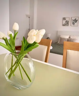 a vase with white flowers sitting on a table at Tierra in Valencia