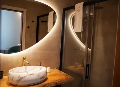 a bathroom with a round sink and a shower at Masia de Matuta in Vall de Almonacid