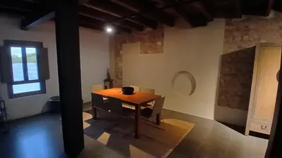a table and chairs in a room with a window at Loft en molino rehabilitado in Paterna