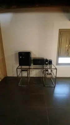 two televisions sitting on a glass table in a room at Loft en molino rehabilitado in Paterna
