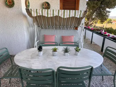 two beds with blue sheets and a table with a lamp at Mediterranean House in Valencia in Valencia