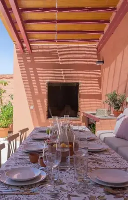 a long table with glasses and plates on a patio at La Casa del Mar in Valencia