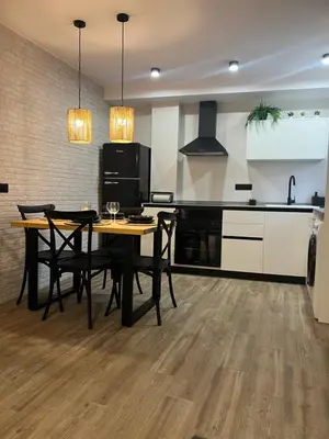 a kitchen with a table and chairs in a room at El refugio del mar in Playa de Mar