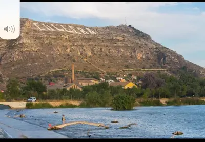 a mountain in the background of a body of water at Acogedor Apartamento Cullera 200 metros playa in Cullera
