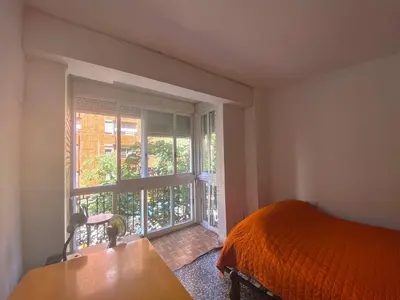 a bedroom with a bed and a large window at Family flat zona Aragon close to city center and beach in Valencia