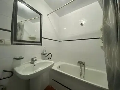 a bathroom with a sink and a tub and a mirror at Family flat zona Aragon close to city center and beach in Valencia