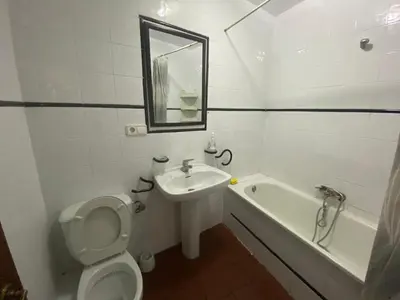 a bathroom with a toilet and a sink and a tub at Family flat zona Aragon close to city center and beach in Valencia