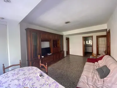 a living room with a couch and a tv at Family flat zona Aragon close to city center and beach in Valencia
