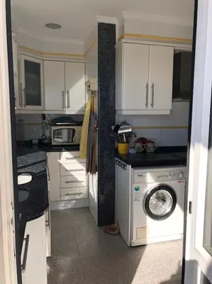 a kitchen with a washing machine and a washer at A modern House with Perfect Views in Mareny Blau
