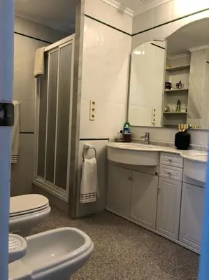 a bathroom with a sink and a toilet and a mirror at A modern House with Perfect Views in Mareny Blau