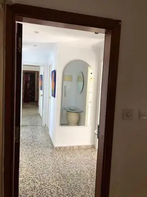 a hallway of a bathroom with a toilet in a mirror at A modern House with Perfect Views in Mareny Blau