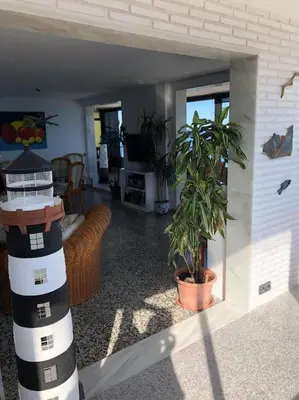 a living room with a house with a plant in it at A modern House with Perfect Views in Mareny Blau