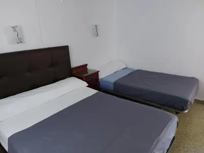 two twin beds in a room with at Victoria, 8-22 in Cullera