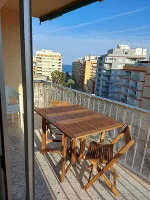 a wooden table and chairs on a balcony at Victoria, 8-22 in Cullera
