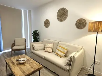 a living room with a couch and a table at Precioso apartamento en la playa in Valencia
