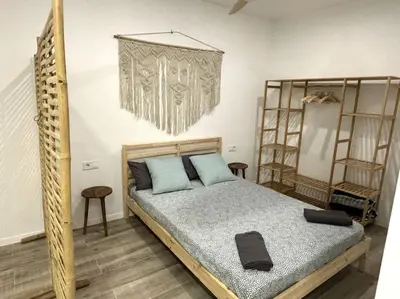 a bedroom with a bed with blue pillows at Precioso apartamento en la playa in Valencia