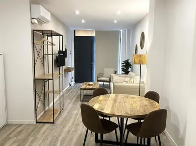 a living room with a table and chairs at Precioso apartamento en la playa in Valencia