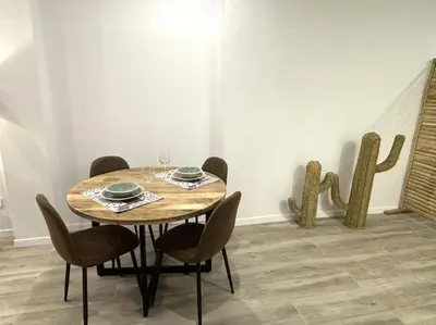 a table and chairs in a room with the word cafe at Precioso apartamento en la playa in Valencia