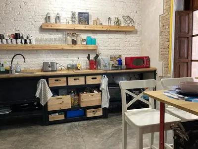 a kitchen with a counter with a sink and a table at La Auténtica in Valencia