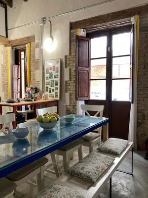 a dining room with a table with bowls of fruit on it at La Auténtica in Valencia