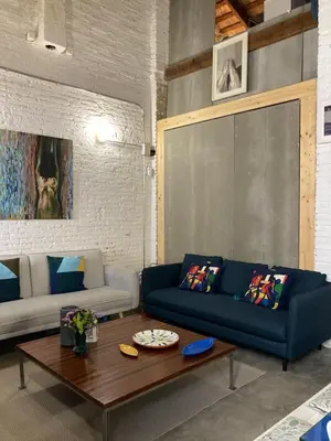 a living room with a blue couch and a coffee table at La Auténtica in Valencia