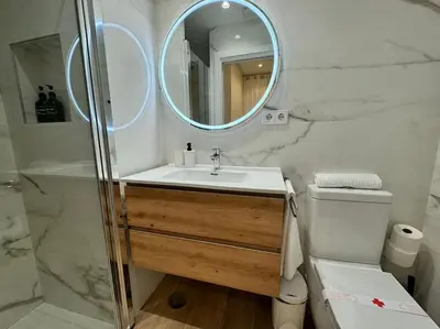 a bathroom with a sink and a mirror and a toilet at Como en casa in Puerto de Sagunto