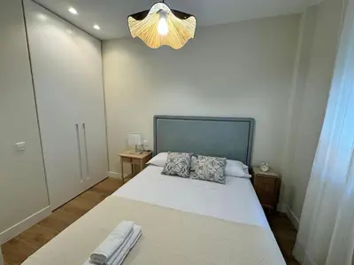 a bedroom with a large white bed with two pillows at Como en casa in Puerto de Sagunto