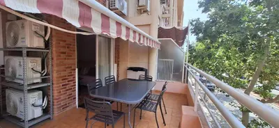 a patio with a table and chairs on a balcony at Vacaciones en el mar in Puerto de Sagunto