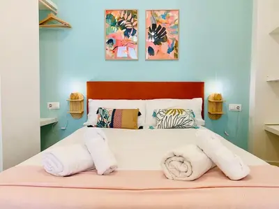 a bedroom with a bed with white towels on it at Beautiful and Charming Loft in Russafa SOHO in Valencia