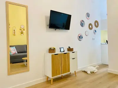 a living room with a tv and a mirror at Beautiful and Charming Loft in Russafa SOHO in Valencia